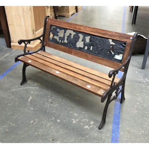 959 - A child's garden bench with cast metal safari back