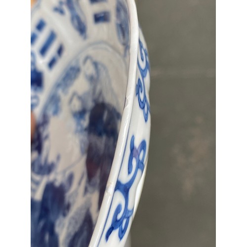 332 - A Chinese blue and white dish with shaped edge, depicting scholars reading a scroll, character marks... 