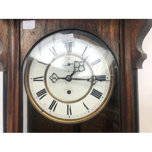 88 - A 20th century mahogany cased wall clock, enamel dial with Roman numerals, 120cmL