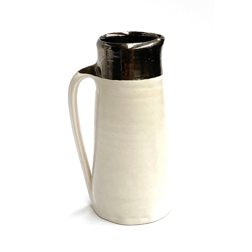 132 - Nicola Tassie (b.1960), a studio pottery jug with silvered rim, marked to base, 17cmH