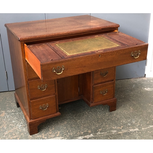 579 - A small 20th century kneehole secretaire desk in 18th century style, the sliding drawer revealing a ... 