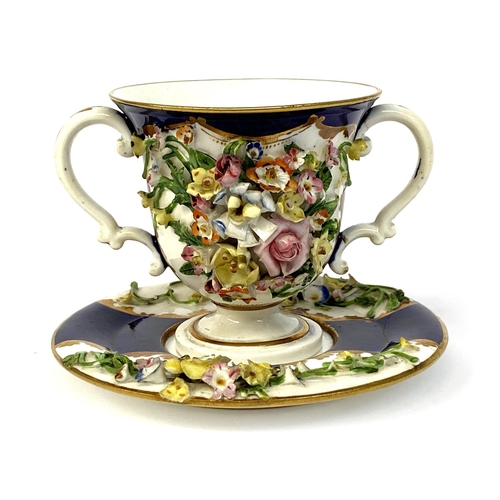 137 - A 19th century Derby porcelain twin handled cup and saucer with floral encrusted decoration, 8cmH