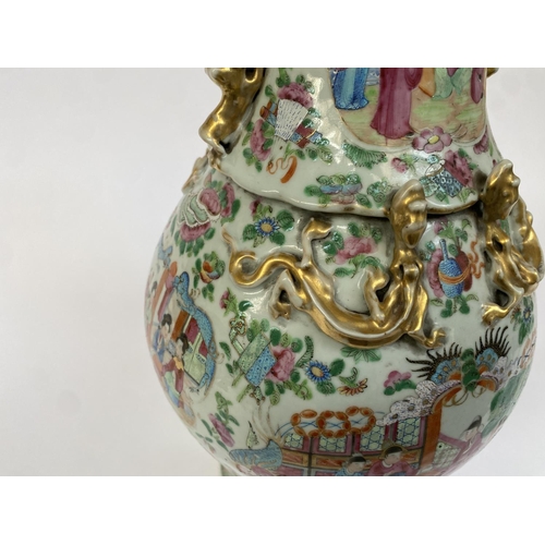 138 - A 19th century Chinese famille rose baluster vase (af), painted with court scenes, with twin foo dog... 