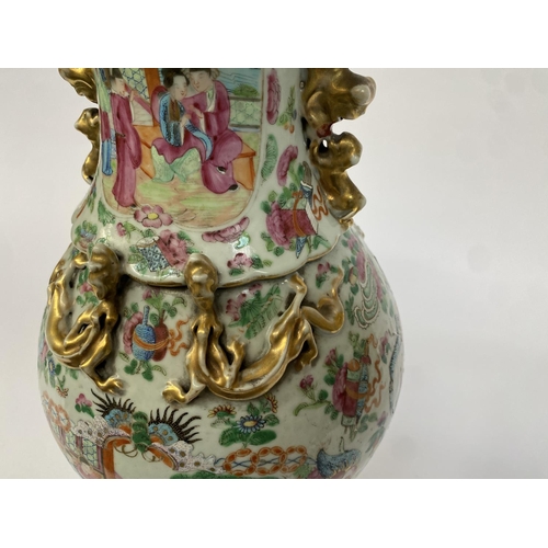 138 - A 19th century Chinese famille rose baluster vase (af), painted with court scenes, with twin foo dog... 