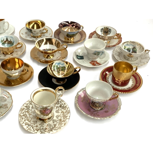 167 - A large collection of approx. 42 mainly German souvenir coffee cups and saucers to include Johann Fe... 