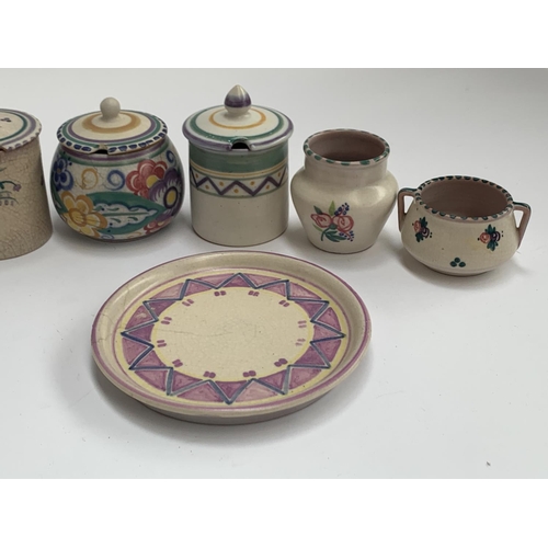 179 - A collection of Poole Carter Stabler Adams pottery, c.1921-34, comprising vases, jam pots, a jug 12c... 