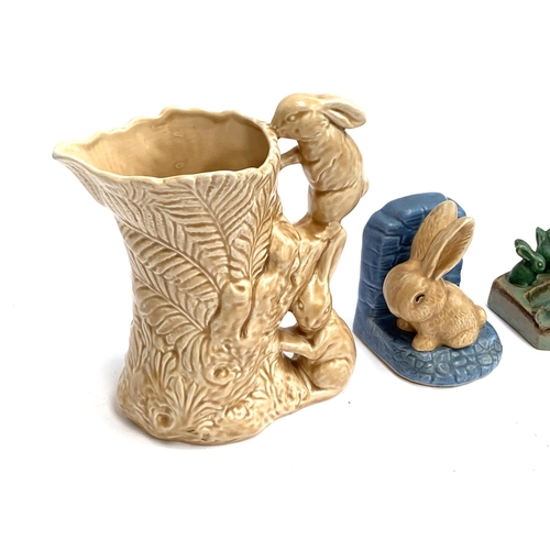 181 - Three pieces of 1930s Sylvac, a bunny jug, 21.5cmH, bunny bookend and small Thistle jug; together wi... 