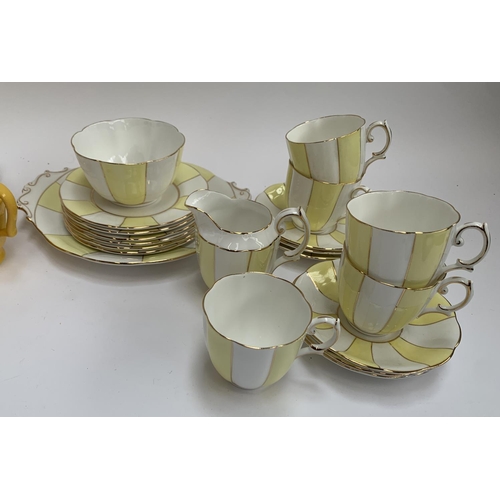 183 - A Royal Albert yellow and white striped part tea service together with a further yellow part tea ser... 