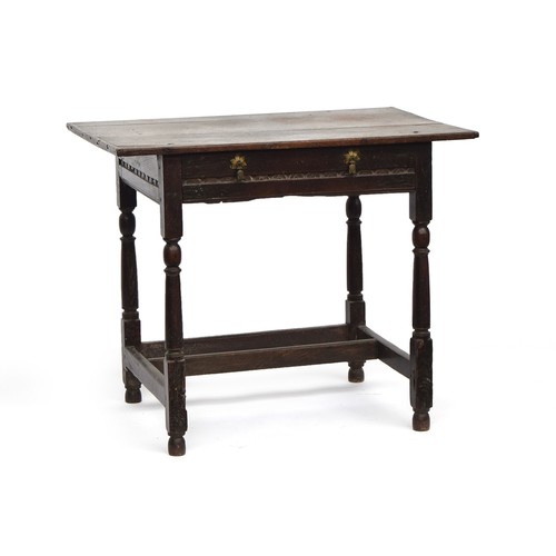 750 - A 17th century oak side table, plank top with cleated ends, single carved frieze drawer, on reel tur... 