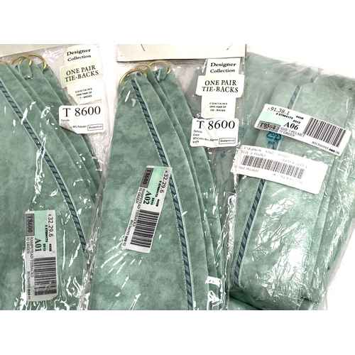 616 - A quantity of sealed green satin La Lima curtains, pelmets and ties