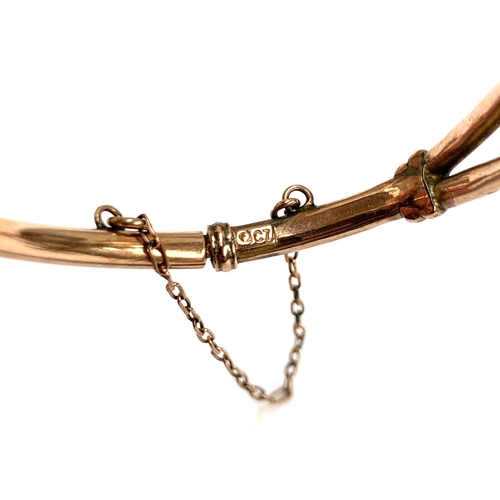 18 - A 9ct gold child's bangle, solder repair to hinge, 6cmW, 4.7g; together with a 1/5th 9ct gold bronze... 