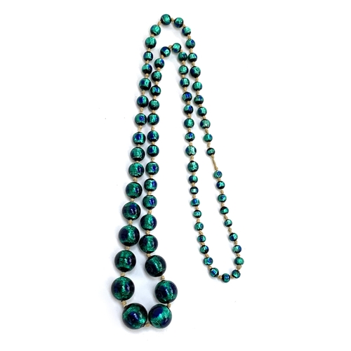 29 - A Czech Art Deco foiled peacock glass bead necklace, the largest bead 1.7cm, 42cmL