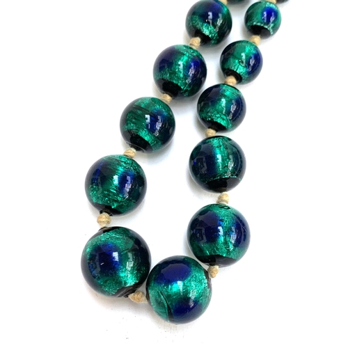 29 - A Czech Art Deco foiled peacock glass bead necklace, the largest bead 1.7cm, 42cmL