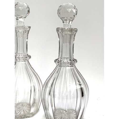 202 - A near pair of cut glass decanters, each approx. 32cmH