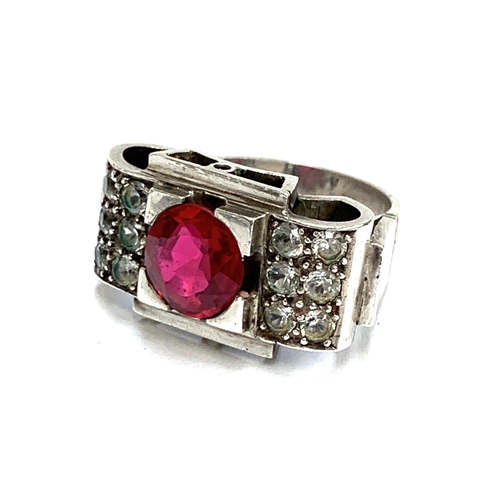 34 - A substantial European 1920s Art Deco silver tank ring set with a central synthetic ruby and paste, ... 