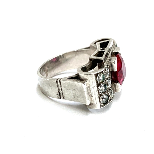 34 - A substantial European 1920s Art Deco silver tank ring set with a central synthetic ruby and paste, ... 