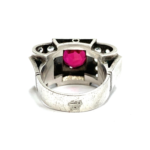 34 - A substantial European 1920s Art Deco silver tank ring set with a central synthetic ruby and paste, ... 