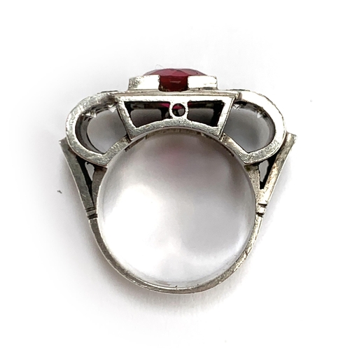 34 - A substantial European 1920s Art Deco silver tank ring set with a central synthetic ruby and paste, ... 