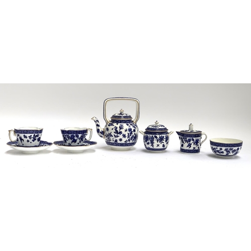 212 - A blue and white porcelain tea set, heightened in gilt, comprising teapot, teacups, saucers, milk ju... 