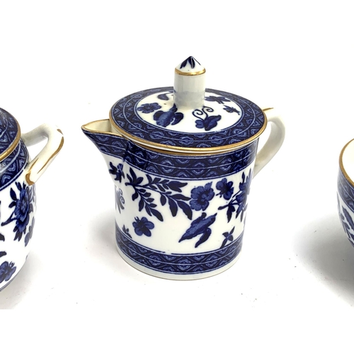 212 - A blue and white porcelain tea set, heightened in gilt, comprising teapot, teacups, saucers, milk ju... 