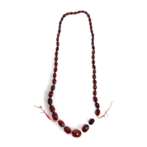 40 - A cherry amber bakelite faceted bead necklace (af), the largest bead 3.2cm, gross weight 96.4g