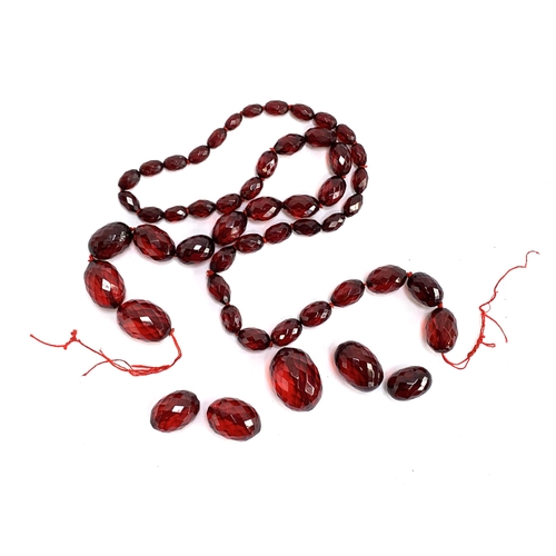 40 - A cherry amber bakelite faceted bead necklace (af), the largest bead 3.2cm, gross weight 96.4g