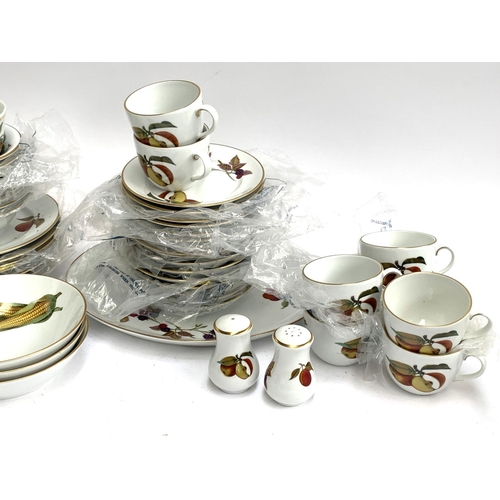 221 - A Royal Worcester 'Evesham' part dinner service to include teacups, bowls, side plates, dinner plate... 