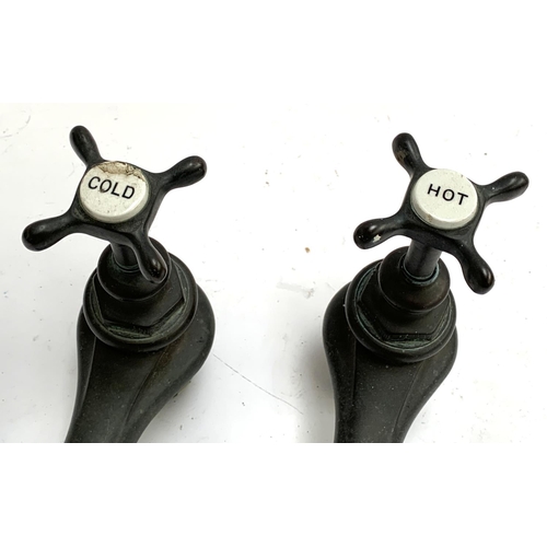 302 - A pair of Victorian bronze bath taps with ceramic labels (cold af), approx. 21cmH overall (15cmH whe... 