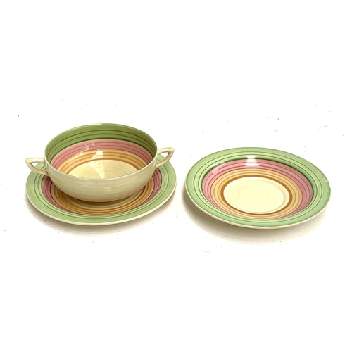 225 - A Clarice Cliff Bizarre Wilkinson Limited tri coloured twin handled cup, 12cmD, saucer and dish