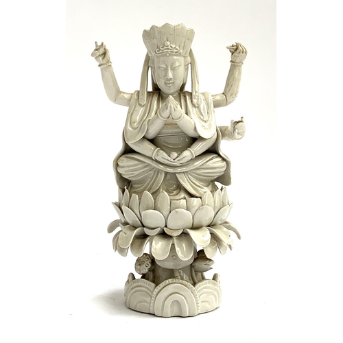 187 - A Chinese blanc de chine porcelain figure of Guanyin the Boddhisatva of Compassion seated on a lotus... 