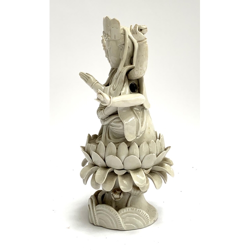 187 - A Chinese blanc de chine porcelain figure of Guanyin the Boddhisatva of Compassion seated on a lotus... 