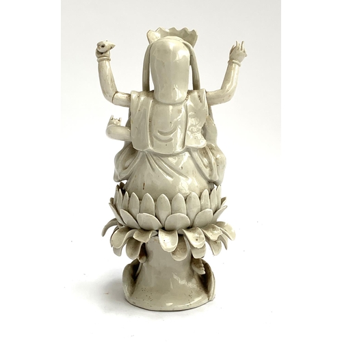 187 - A Chinese blanc de chine porcelain figure of Guanyin the Boddhisatva of Compassion seated on a lotus... 