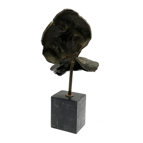 312 - A bronze abstract sculpture of a mask leaning on a hand, on plinth, 46cmH