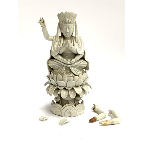 187 - A Chinese blanc de chine porcelain figure of Guanyin the Boddhisatva of Compassion seated on a lotus... 