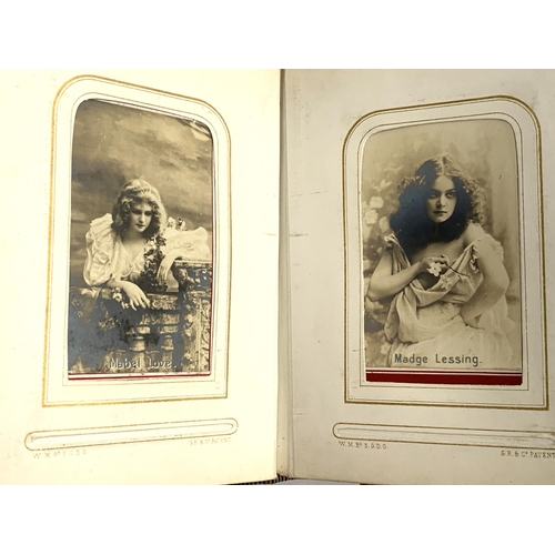 266 - A small photograph album containing a quantity of late 19th and early 20th century postcards, drawin... 