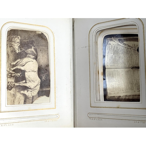 266 - A small photograph album containing a quantity of late 19th and early 20th century postcards, drawin... 