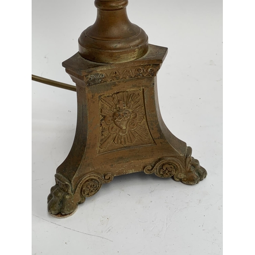 323 - A brass Corinthian column table lamp, the base with immaculate heart, possibly from a Church (wobbly... 