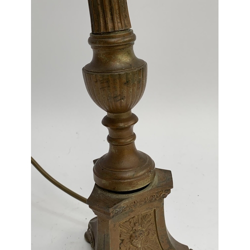 323 - A brass Corinthian column table lamp, the base with immaculate heart, possibly from a Church (wobbly... 