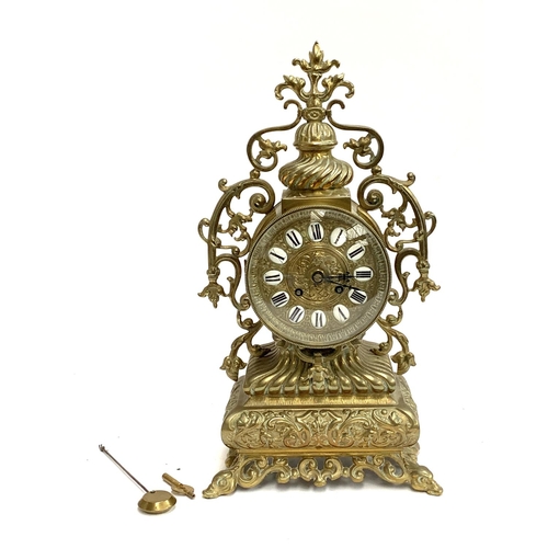 95 - A French brass Rococo style mantle clock, the dial with Roman numerals, 43cmH