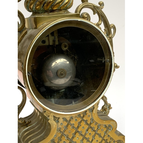 95 - A French brass Rococo style mantle clock, the dial with Roman numerals, 43cmH