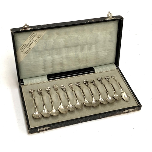 103 - A cased set of 12 Dutch silver coffee spoons, with flower terminals, one af, retailed by G. Schoorl