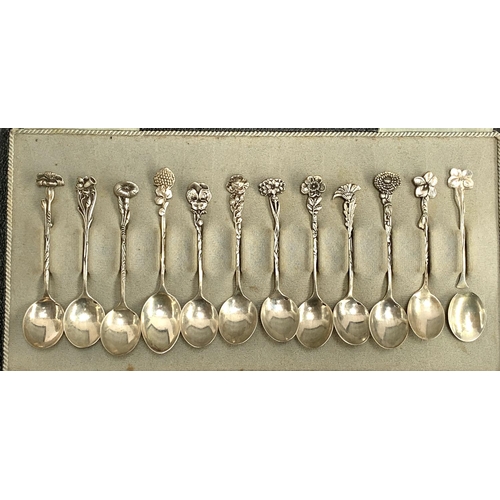 103 - A cased set of 12 Dutch silver coffee spoons, with flower terminals, one af, retailed by G. Schoorl