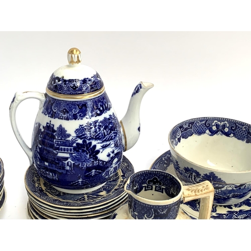 194 - A quantity of blue and white ceramics, mainly Willow pattern part tea service, including teapot with... 