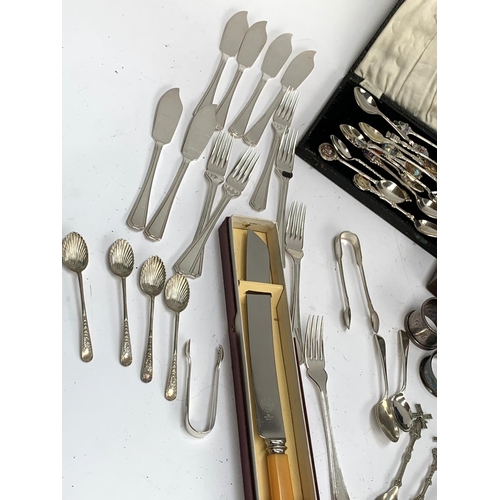 118 - A quantity of silver plated flatware, napkin rings, souvenir spoons etc