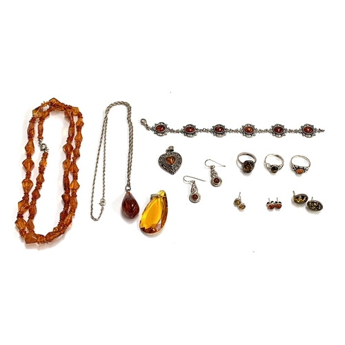 60 - A quantity of amber and amber type jewellery, to include silver rings, stud earrings silver heart sh... 