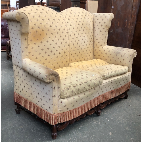 669 - Interior design interest: A Victorian high wingback two seater sofa, with a carved mahogany frieze, ... 