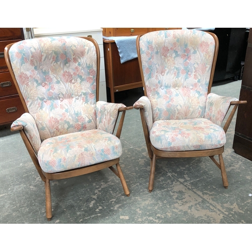 688 - An Ercol three piece suite, comprising two stickback armchairs and a two seater sofa, 144cmW