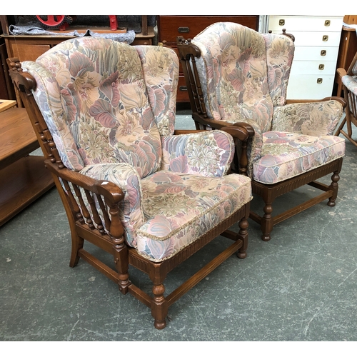 689 - A pair of Ercol elm spindle wingback armchairs, each approx. 84cmW