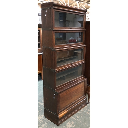 711 - A Globe Wernicke five part glazed oak sectional bookcase, bears label 87cmW, 191cmH