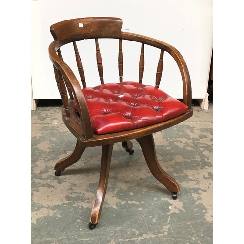 747 - A 20th century spindle back office chair with red vinyl button upholstered seat